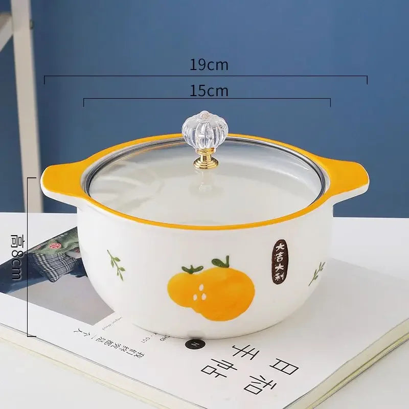 An orange designed kawaii ramen bowl on a table